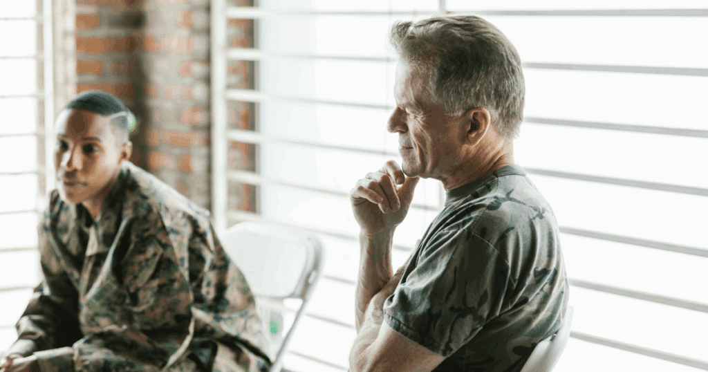Bipolar disorder therapy group showing diverse veterans in supportive session, promoting mental health and empowering connections.